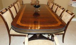 Oak Table, restored, in excellent condition. The table measures 42" Wide, 8' Long. There are an additional 2 leaves that measure 2' Each which would then bring the table to 10'-12' depending on how many leaves you choose to use. There are also 12 oak