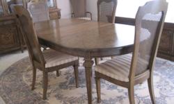 This is as described, a complete set from 1969; made of fruitwood and consists of a dining table, two extensions, six chairs, a two part china closet (base and top) and a buffet (side board), and custom table pads. The table measures 64" closed and has