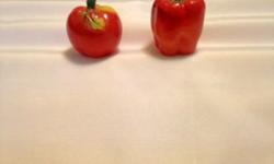 vintage ceramic tomato and pepper shakers, with cork stopper, The pepper shaker is 2 1/4" high and 1 1/2" wide. The tomato is 2" tall and 1 3/4" wide. Both have very slight imperfections in the glaze. The pepper has a shiny glaze than the tomato. Both