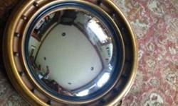 Vintage Federal Style Convex Wall Mirror with Eagle Motif and Ornate Scroll Design .
Antiqued Gold Finish on Molded Resin with wood frame.
Measuring approximately 39'' tall x 25" across.
During the 19th century in the Neo- Classical Regency, Georgian and