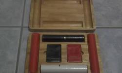 Vintage Marlboro Poker Set in Wooden Case.
The poker chips and cards are sealed in plastic.
2 rolls of red chips, 1 roll of black and 1 roll of white chips.
2 decks of cards.
The wooden case has scratches, chips, marks and glue marks.
I am not a