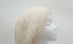 The color of this hat is a winter white (off white) wool color. It is made with a soft pure wool yarn. It is a medium thickness, very stretchy, will fit any head, will stretch out to 31 inches around. This pattern is called ?tracks?. The measurements are