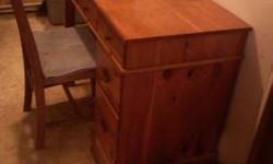 Located in Chaumont, NY. Wood desk, all genuine wood except pressboard behind side drawers, has one scratch on top that can be sanded out or treated to cover, with chair, 37 inches long by 20 inches wide and 30 inches tall, please email with interest