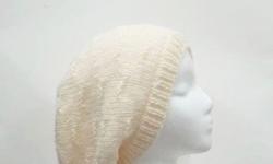 The color of this wool slouch hat is a winter white (off white) color. It is made with a soft pure wool yarn. It is a medium thickness, very stretchy, will fit any head, will stretch out to 31 inches around. This pattern is called ?tracks?. Fits adult